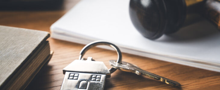 Gavel and house key on the table